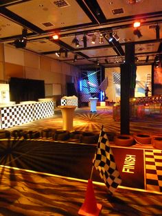 an empty room with checkered walls and black and white flags on the floor in front of them