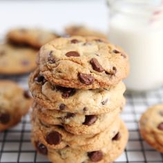 a stack of chocolate chip cookies next to a glass of milk