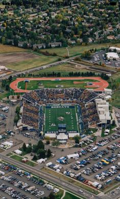 an aerial view of a football field and parking lot