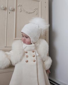 Petite Maison Kids. Ivory color genuine wool coat, fully lined. Gold button closure. Natural fur trim at shoulders and hands. Pleated back design. 100% Wool. Cape sold separately. White Classic Wool Coat, Classic White Wool Coat, Classic White Fur Coat For Winter, Elegant Cream Fur Coat With Faux Fur Trim, Classic Beige Fur Coat With Faux Fur Trim, Wool Cape, Luxury Baby, White Coat