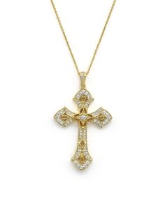 An ornate cross pendant shines with diamonds on a 14K yellow gold chain. Yellow Gold Cubic Zirconia Cross Necklace, Luxury Crucifix Cross Necklace For Formal Occasions, Yellow Gold Diamond Cross Pendant Necklace, Yellow Gold Cross Diamond Necklace With Cubic Zirconia, Luxury Pendant Cross Necklace With Diamond Accents, Yellow Gold Cubic Zirconia Cross Diamond Necklace, Luxury Gold Diamond Cross Pendant Necklace, Luxury Cross Pendant Necklace With Diamond Accents, Yellow Gold Cross Pendant Necklace With Diamond Accents