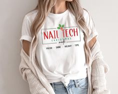 Nail Tech Christmas Mode Shirt, Funny Nail Tech Christmas T-shirt, Holiday Nail Technician Tee, Christmas Gift for Nail Tech Festive Apparel Bella+Canvas Premium T-Shirt Indulge in the timeless appeal of this classic unisex jersey short sleeve tee, designed to feel like a well-loved favorite. Crafted from soft cotton and featuring a quality print, this shirt is destined to become your go-to wardrobe staple. The ribbed knit collar enhances shaping, while taped shoulders ensure a better fit over t Nail Tech Shirts, Tech T Shirts, Tech Shirt, Nail Technician, Holiday Nails, Christmas Tshirts, Nail Tech, Wardrobe Staples, Short Sleeve Tee