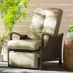 a chair sitting next to a potted plant