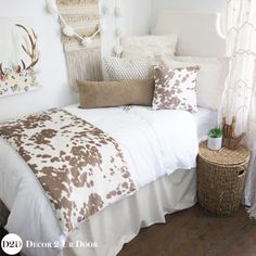 a bed with white and brown pillows on top of it