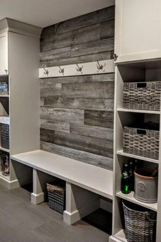 a room with some shelves and baskets on the wall next to it, along with other items