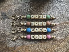 three keychains with the word mama spelled out in small letters and beads on them