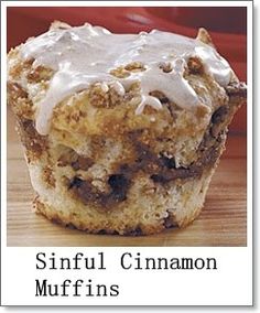 a close up of a muffin on a wooden table with the words sinful cinnamon muffins