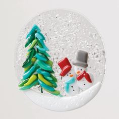 a snowman and a christmas tree on a plate