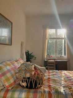 a bed in a bedroom with a basket on it's headboard next to a window