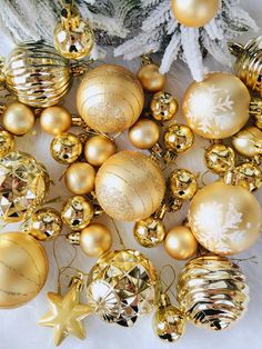 gold christmas balls and ornaments on white furnishing