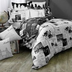 black and white photograph of a bed with many pillows on top of it in a bedroom