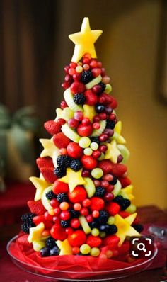 a christmas tree made out of fruit on a plate