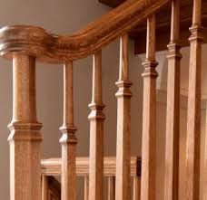 a wooden banister with spindles and handrails