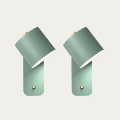 two green lamps on a white wall