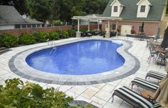 an above ground pool surrounded by patio furniture