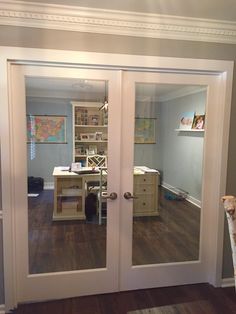 an empty room with glass doors leading into the office