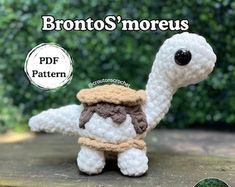 a crocheted brontosaurus with a hat on it's head