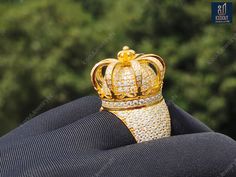 a gold crown ring sitting on top of someone's lap