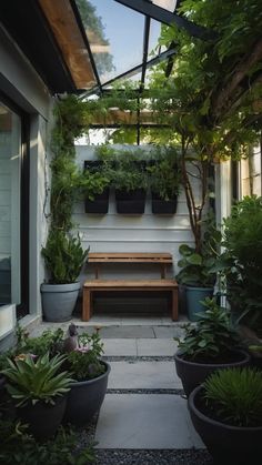 an outdoor patio with potted plants and a bench