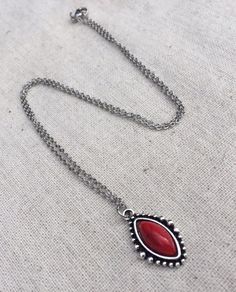 "Simple, chic and versatile! Here is a red stone necklace that is set in a perfectly detailed silver frame. The perfect everyday necklace! Made from allergy free plated silver. The pendant measures 1\" long by 1/2\" wide. It hangs from a shiny strong 18\" stainless steel necklace chain with a lobster clasp. I have matching earrings in my shop if you would like the whole set. Here is the link https://etsy.me/2R5NsWx I have this same style pendant necklace available in other color ways as well! He Southwestern Style Red Jewelry For Gift, Southwestern Style Red Jewelry For Gifts, Red Southwestern Style Jewelry Gift, Red Necklace With Oxidized Finish For Gift, Southwestern Style Red Necklace For Gift, Bohemian Nickel Free Oval Pendant Necklace, Red Oxidized Finish Necklace For Gift, Southwestern Style Red Gemstone Jewelry, Red Southwestern Turquoise Necklace For Gift