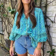 Gorgeous Blue Boho Floral Printed Button Up V-Neckline Blouse With Tassel Fringed Tie And Wide Elastic Hemmed Sleeves. Size Fit: Small: 2-4 Medium: 4-6 Large: 6-8 Material: 100% Viscose Measurements: Small: Bust: 37" Sleeve: 23.2" Length: 28.74" Medium: Bust: 38.5" Sleeve: 23.6" Length: 29.1" Large: Bust: 40.1" Sleeve: 24" Length: 29.5" Our Boutique Is Filled With A Curated Collection Of Styles: Spell Gypsy Boho Bohemian Hippie Retro Vintage Handmade Coachella Festival Free People Anthropologie Casual Turquoise V-neck Blouse, Blue V-neck Tops With Buttons, Bohemian Spring Blouse With Buttons, Green V-neck Blouse With Buttons, Spring Bohemian Blouse With Buttons, Bohemian Beach Blouse With Buttons, Bohemian Blouse With Buttons For The Beach, Summer Split Neck Blouse With Buttons, Summer Blouse With Split Neck And Buttons