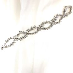 This delicate bridal hair vine is finished with a glamorous luster and fine detailing. Its shimmering structure intertwined with illuminating crystals is sure to make this piece a head turner as it glows and frames your gorgeous wedding look. Use it in the front or back of an updo, around a bun, and many other ways. Available in all crystal or crystal and pearl, and comes in silver or gold. -Genuine crystals -Approximately 1.5in at the widest point x 14in long (3.8cm x 35.6cm) -Rhodium or gold p Adjustable Crystal Embellished Hair Accessories For Weddings, Elegant Crystal Embellished Jewelry Headband, Elegant Adjustable Hair Accessories For Ceremony, Elegant Silver Hair Accessories For Evening, Adjustable Crystal Embellished Headpieces For Wedding, Elegant Silver Bridal Belt For Wedding, Elegant Adjustable Bridal Accessories, Elegant Ceremony Headband Hair Accessories, Elegant Headband Hair Accessories For Ceremony