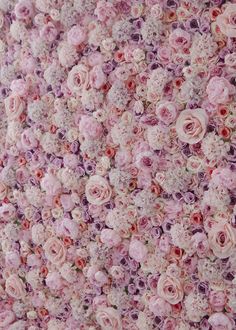 a wall covered in lots of pink and white flowers