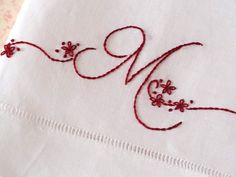 a close up of a piece of cloth with stitching on it and the word love written in red thread