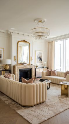 a living room filled with furniture and a fire place in front of a large window