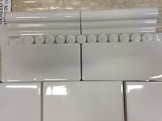 several white tiles are stacked on top of each other in the same pattern and size