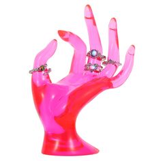 a pink plastic hand with rings on it