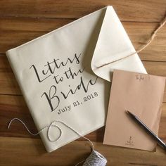 a couple of pieces of paper sitting on top of a table next to a ball of yarn