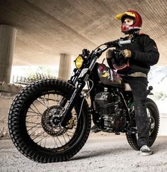 a man sitting on top of a motorcycle