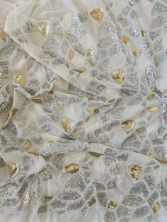 Sequin magic! Gorgeous white, gold and silver georgette fabric with mosaic sequin embroidered work all over. Please scroll through the pictures for sequin size. Perfect for skirts, jackets, shrugs, crop top, mask, blouse, the choices are endless!! Width 42in, Sequin area 36in This listing is for one yard, if bought in multiple quantities it comes as one continuous piece Please confirm your quantity before placing the order, no returns and no exchanges! Free shipping, delivery in 3-5 business day White Sequin Fabric For Festive Season, White Sequin Fabric For Festive Occasions, Festive White Sequin Fabric, Metallic Embellished Sequin Fabric For Festive Occasions, Festive White Embellished Sequin Fabric, Silver Sequined Embroidered Fabric For Party, Silver Embroidered Fabric With Sequins For Parties, Silver Embroidered Fabric With Sequins For Festive Occasions, White Embellished Embroidered Fabric For Celebrations