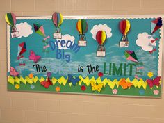 a bulletin board with colorful paper hot air balloons and words on it that say the sky is the limit