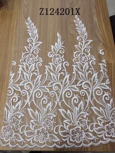 the white lace is on top of a wooden table