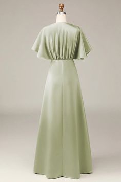 the back of a dress on a mannequin's head, in light green