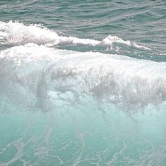 a man riding a wave on top of a surfboard