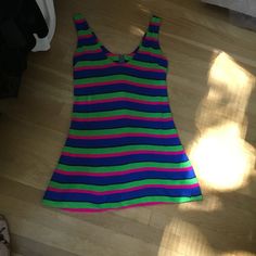 "This is one funky little mini from the 70's. The fabric is a poly/jersey blend and the design is bold colored stripes...hot pink, lime green and royal blue. Scoop necked with zipper down back. It could be worn as a mini dress or as a fun top with leggings. Hand made many years ago, still in nice wearable shape. Measurements: 36\" bust; mid body 33\"; 38\" hips; 51\" hemline; 32 1/2\" tall. Thanks for stopping by my Etsy shop!" Retro Fitted Mini Dress, Fitted Retro Mini Dress, Vintage Cotton Mini Dress, Striped Cotton Mini Dress, Striped Fitted Cotton Mini Dress, Fitted Striped Cotton Mini Dress, Y2k Style Green Mini Dress, Green Y2k Style Mini Dress, Y2k Green Mini Dress