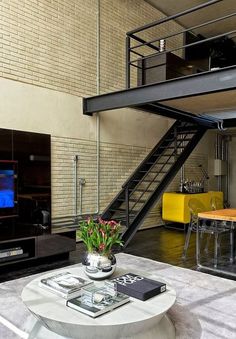 a living room filled with furniture and a flat screen tv sitting on top of a table