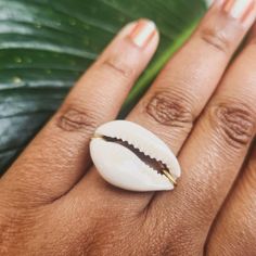 This simple, unadorned handmade unisex ring is made with natural genuine cowrie sea shells, and is available in sizes 0 through 13. The rings are available with 3 kinds of wire: 100% copper wire, gold-colored German wire, or stainless steel wire. These rings are wrapped by hand, meaning each ring is unique, but done in the same style.  Throughout Africa and the Americas, cowrie shells have historically been viewed as symbols of womanhood, fertility, and prosperity.  Please choose your ring size Handmade White Shell Rings, Summer Beach Jewelry Ring, Beach Summer Jewelry Ring, Ocean-inspired Shell Rings For Beach, White Shell-shaped Rings For Beach, White Beach Ring Jewelry, Gold Shell Rings For Beach, Handmade Shell Ring For Beach, White Shell Rings For The Beach