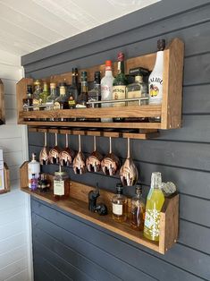 a shelf filled with lots of bottles on top of a wall