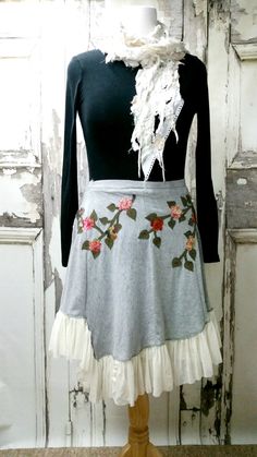 a mannequin wearing a skirt with roses on it and ruffles around the waist