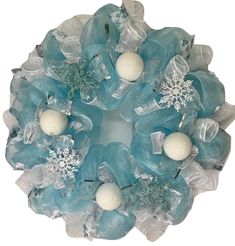 a wreath with snowflakes and balls on it