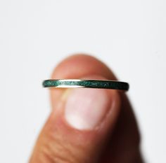 Unisex wedding band with an emerald inlay. A modern & simple wedding band for him or her. Price is for 2mm wide band.
The width of the band can be changed per request.
Details Gemstone: crushed genuine emerald, select the inlay from the drop down menu Band measurements: approx. 2mm wide
Material: 14k/18k yellow/white/rose gold or platinum. The listing is for 14k gold; for 18k gold and platinum there is some extra fee.  Size: 2-12 (Larger and smaller sizes are available as well. Priced upon reque Wedding Band Additions, Modern Jade Jewellery, Creative Wedding Bands, Simple Engagement Bands For Women, Unisex Engagement Rings, Lesbian Wedding Bands, Jade Wedding Band, Wedding Bands Emerald, Jade Wedding Ring