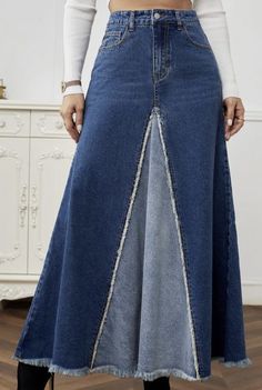 a woman in a white top is wearing a denim skirt with an asymmetrical design