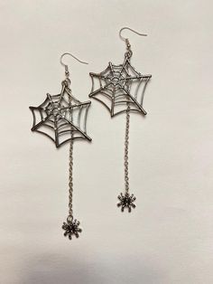 Spider spun himself a beautiful little web!  Dangle earrings.  Great to jazz up your Halloween outfit! LONG spider and web earrings! Web has rhinestone accents. Approximately 4-5/8" long. Not intended for children ages 13 and under.   Also, for many items we can accommodate large orders, so please send us a message. Edgy Pierced Halloween Earrings, Edgy Halloween Pierced Earrings, Edgy Pierced Earrings For Halloween, Edgy Dangle Earrings For Halloween, Punk Halloween Drop Earrings, Punk Style Halloween Drop Earrings, Edgy Silver Earrings For Halloween, Silver Spooky Halloween Earrings, Halloween Themed Silver Earrings