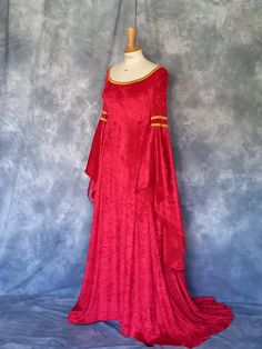 Medieval Gown,Elvish Dress,Celtic Gown,Custom Made,Hand Fasting Dress,Robe Medievale,Robe Elfique,Renaissance Dress,Grace. Grace, a medieval wedding dress, eleganty styled in red crushed velvet with old gold trim ( other colours available ). Back corset style lacing allows for a little adjustment. The inner sleeves are in a soft organza. Grace is designed and custom made by Gill Linley of frockfollies. Perfect as a Hand Fasting Dress or an Elvish Wedding Dress. CHECK OUT http://www.frockfollies.com for other designs and colour choices. FREE INSURED AND TRACKABLE SHIPPING Hand made in England by an experienced theatrical costumier, this medieval gown Grace is available to order in a wide choice of colors and will be custom made to your measurements.  frockfollies prides itself on quality of Red Fitted Medieval Dress For Wedding, Fitted Red Vintage Medieval Dress, Fitted Red Medieval Dress With Historical Design, Luxury Fitted Red Medieval Dress, Elvish Wedding Dress, Medieval Red Dress With Historical Design, Elvish Dress, Elvish Wedding, Medieval Wedding Dress