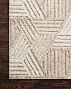 a white rug on top of a wooden floor