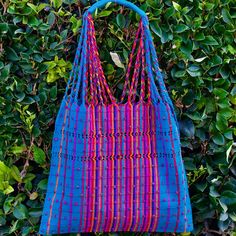 This unique bag is beautifully made on a waist loom, (Telar de Cintura) by artisans from Chiapas México. Each bag is individually handwoven with a unique colors and designs . There is not other like it! Use this reusable and eco-friendly, 100% cotton loom tote bag as a shopping bag for farmer's markets . Dress it down with a t-shirt and jeans or shorts! or to add a boho vibe to any outfit. Details: Tote measurements: 14 x 16.5 inch Handle drop: 10" Material: 100% Cotton Color: blue with colorful Artisan Blue Handwoven Bags, Artisan Handwoven Blue Shoulder Bag, Blue Artisan Handwoven Shoulder Bag, Artisan Blue Handwoven Shoulder Bag, Traditional Blue Handwoven Shoulder Bag, Eco-friendly Woven Beach Bag For Market, Traditional Blue Handwoven Bags, Eco-friendly Handwoven Blue Shoulder Bag, Eco-friendly Blue Handwoven Shoulder Bag